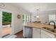 Kitchen featuring granite counters, stainless dishwasher and view to deck at 4278 Park South Station Blvd, Charlotte, NC 28210