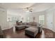 Open-concept living room with dark hardwood floors, a sectional sofa, and a dining area at 4278 Park South Station Blvd, Charlotte, NC 28210