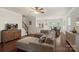 Spacious open-concept living area with hardwood floors, a ceiling fan, and natural light at 4278 Park South Station Blvd, Charlotte, NC 28210