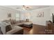Open-concept living room with dark hardwood floors, a sectional sofa, and neutral walls at 4278 Park South Station Blvd, Charlotte, NC 28210