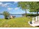 Lush backyard with mature trees leading to a dock on the lake, perfect for outdoor living at 4586 Doctor Dr, Catawba, NC 28609