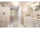 Bathroom with white vanity, tiled shower, and window providing natural light in neutral decor at 4586 Doctor Dr, Catawba, NC 28609