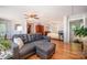 Open concept living and bedroom with a gray sofa, hardwood floors, ceiling fans, and natural lighting at 4586 Doctor Dr, Catawba, NC 28609