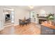 Dining room with hardwood-style floors, wood table and black chairs, and a fireplace with teal trim at 4586 Doctor Dr, Catawba, NC 28609
