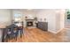 Open dining area with hardwood-style floors, a green-trimmed fireplace, black chairs, and a view of the entry at 4586 Doctor Dr, Catawba, NC 28609
