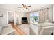Bright living room with hardwood floors, ceiling fan, and sliding glass doors to the outdoor deck overlooking the lake at 4586 Doctor Dr, Catawba, NC 28609