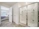 The bright bathroom features a glass shower, white walls, and updated fixtures at 461 Misty Law Ln, Clover, SC 29710