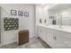 The bright bathroom showcases double sinks, white cabinets, modern fixtures and tiled flooring at 461 Misty Law Ln, Clover, SC 29710