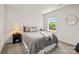 Neutral-toned bedroom with a cozy bed, side table, and bright natural light at 461 Misty Law Ln, Clover, SC 29710