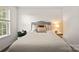 Relaxing bedroom features a bed with accent pillows, a side table with lamp, and soft lighting at 461 Misty Law Ln, Clover, SC 29710