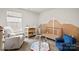 Inviting Bedroom with crib, changing station, and cozy seating area with natural light at 461 Misty Law Ln, Clover, SC 29710