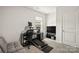 Bright bedroom featuring a gray futon, black desk setup, and a television stand at 461 Misty Law Ln, Clover, SC 29710