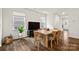 Bright dining area features a wooden table for six, modern decor, and hardwood floors at 461 Misty Law Ln, Clover, SC 29710