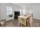 Bright dining area with hardwood floors, large windows, and an open layout enhances the home's appeal at 461 Misty Law Ln, Clover, SC 29710