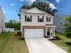Two-story home with brick accents, a two-car garage, and a well-manicured front yard at 461 Misty Law Ln, Clover, SC 29710
