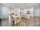 Open-concept kitchen featuring a large island with bar seating that flows into the adjacent dining area at 461 Misty Law Ln, Clover, SC 29710