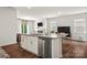Bright kitchen featuring a granite island, stainless dishwasher, and an open view to the dining area at 461 Misty Law Ln, Clover, SC 29710