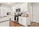 Well-lit kitchen featuring white cabinets, stainless appliances, and granite countertops at 461 Misty Law Ln, Clover, SC 29710