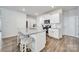 Bright kitchen features a granite island with bar stool seating, stainless steel appliances, and white cabinets at 461 Misty Law Ln, Clover, SC 29710