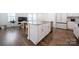 Open kitchen includes a granite island with stainless steel sink, seating, and appliances, and lots of white cabinets at 461 Misty Law Ln, Clover, SC 29710