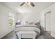 Bright main bedroom features a ceiling fan, a cushioned bench, and soft, neutral decor at 461 Misty Law Ln, Clover, SC 29710