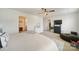 This main bedroom features neutral walls, a ceiling fan, dresser, TV and a walk-in closet at 461 Misty Law Ln, Clover, SC 29710