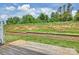 Spacious backyard features a retaining wall, grass, wooden deck, and fencing at 502 Tayberry Ln, Fort Mill, SC 29715