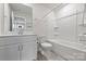 Bright bathroom features a tub, toilet, vanity with sink, and large mirror at 502 Tayberry Ln, Fort Mill, SC 29715