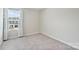 Well-lit bedroom with neutral carpet and large window, ready for personal touches at 502 Tayberry Ln, Fort Mill, SC 29715