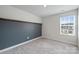 Bedroom with accent wall, neutral carpet, and a window offering natural light at 502 Tayberry Ln, Fort Mill, SC 29715