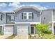 New construction home featuring gray siding, a covered entry, an attached garage, and a landscaped front yard at 502 Tayberry Ln, Fort Mill, SC 29715
