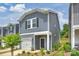 New construction home featuring gray siding, covered entry, attached garage, and landscaped front yard at 502 Tayberry Ln, Fort Mill, SC 29715