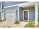 New construction home featuring an attached garage, a covered entry, gray siding, and exterior lighting at 502 Tayberry Ln, Fort Mill, SC 29715