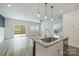 Modern kitchen with granite counters, stainless steel appliances, island with seating open to the living area at 502 Tayberry Ln, Fort Mill, SC 29715