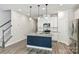Bright kitchen featuring a granite island, white cabinets, and stairs leading to the second floor at 502 Tayberry Ln, Fort Mill, SC 29715