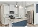 Modern kitchen featuring white cabinets, a granite island, and stainless steel appliances at 502 Tayberry Ln, Fort Mill, SC 29715