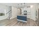 Bright, open-concept kitchen with a large island, and stairs to the second floor at 502 Tayberry Ln, Fort Mill, SC 29715
