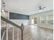 Bright living room with hardwood floors, ceiling fan, and sliding glass door to backyard at 502 Tayberry Ln, Fort Mill, SC 29715