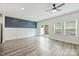 Bright living room with hardwood floors, ceiling fan, and sliding glass door to backyard at 502 Tayberry Ln, Fort Mill, SC 29715