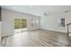 Bright living room featuring hardwood floors, a sliding glass door, and plenty of natural light at 502 Tayberry Ln, Fort Mill, SC 29715