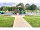 Community playground features multiple slides, swings, and shaded benches at 502 Tayberry Ln, Fort Mill, SC 29715