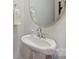 A compact powder room with pedestal sink, oval mirror, and chrome fixtures at 502 Tayberry Ln, Fort Mill, SC 29715