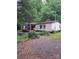 Charming single-story home with mature trees and landscaping around the perimeter at 5023 Dogwood Ln, Stanley, NC 28164