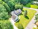 Beautiful aerial view featuring a lush, well-manicured lawn, mature trees, and a charming home with a detached garage at 511 Brookwood Dr, Statesville, NC 28677