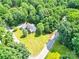 Stunning aerial view of the property showcasing its lush greenery, well-manicured lawn, mature trees, and peaceful neighborhood at 511 Brookwood Dr, Statesville, NC 28677