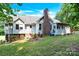 This home features an expansive backyard with lush lawn, brick chimney and mature trees, creating a private retreat at 511 Brookwood Dr, Statesville, NC 28677