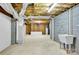 Unfinished basement with concrete floor, walls, sink and utilities at 511 Brookwood Dr, Statesville, NC 28677