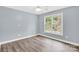Bedroom features hardwood floors, ceiling fan and large window at 511 Brookwood Dr, Statesville, NC 28677