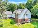 Angle view of a beautiful house with brick foundation and manicured green grass at 511 Brookwood Dr, Statesville, NC 28677