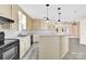 Traditional kitchen featuring light-colored cabinetry, tiled floor, breakfast bar, and stainless steel appliances at 511 Brookwood Dr, Statesville, NC 28677